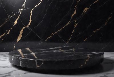 The primary subject of the image is a large, round, black marble countertop. The setting is a room with a black marble wall, which complements the countertop. The visual style is a photo, capturing the details and texture of the marble surface. The colors and mood of the image are dark and sophisticated, with the black marble and the black wall creating a striking contrast.