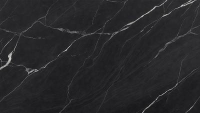 The primary subject of the image is a close-up of a black marble countertop. The setting is a kitchen, with the marble countertop being the main focus of the scene. The visual style is a photo, capturing the intricate details of the marble surface. The colors and mood of the image are predominantly dark, with the black marble providing a striking contrast against the surrounding environment.