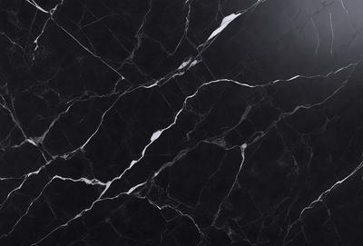 The primary subject of the image is a black marble countertop. The setting is a kitchen, with the countertop being the main focus of the scene. The visual style is a close-up of the marble countertop, showcasing its texture and pattern. The colors and mood of the image are predominantly dark, with the black marble countertop being the main source of contrast.