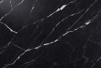 The primary subject of the image is a black marble countertop. The setting is a kitchen, with the countertop being the main focus of the scene. The visual style is a close-up of the marble countertop, showcasing its texture and pattern. The colors and mood of the image are predominantly dark, with the black marble countertop being the main source of contrast.