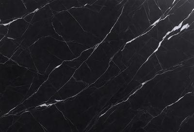 The primary subject of the image is a marble countertop with a black and white pattern. The setting is a kitchen, and the visual style is a close-up of the marble countertop. The colors and mood of the image are predominantly black and white, giving it a classic and elegant appearance.