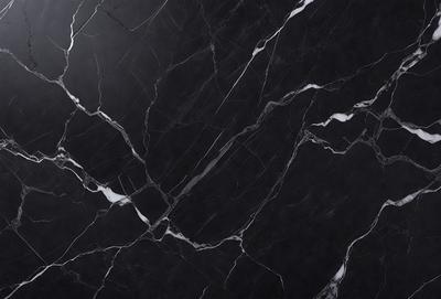 The primary subject of the image is a black marble countertop. The setting is a kitchen, with the countertop being the main focus of the scene. The visual style is a close-up of the marble countertop, showcasing its texture and pattern. The colors and mood of the image are predominantly dark, with the black marble countertop being the main source of contrast and visual interest.