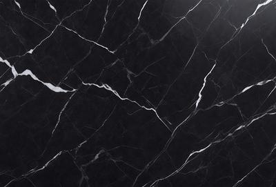 The primary subject of the image is a black marble countertop. The setting is a kitchen, with the countertop being the main focus of the scene. The visual style is a close-up of the marble countertop, showcasing its texture and pattern. The colors and mood of the image are predominantly dark, with the black marble providing a striking contrast against the lighter background.