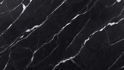 The primary subject of the image is a black marble countertop. The setting is a kitchen, with the countertop being the main focus of the scene. The visual style is a close-up of the marble countertop, showcasing its texture and pattern. The colors and mood of the image are predominantly dark, with the black marble countertop being the main source of contrast.
