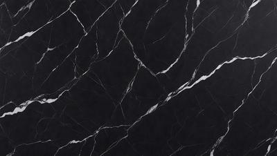 The primary subject of the image is a black marble countertop. The setting is a kitchen, with the countertop being the main focus of the scene. The visual style is a close-up of the marble countertop, showcasing its texture and pattern. The colors and mood of the image are predominantly dark, with the black marble countertop being the main source of contrast.