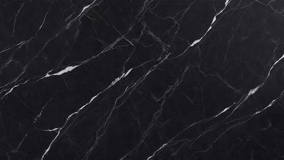 The primary subject of the image is a black marble countertop. The setting is a kitchen, with the countertop being the main focus of the scene. The visual style is a close-up of the marble countertop, showcasing its texture and pattern. The colors and mood of the image are predominantly dark, with the black marble countertop being the main source of contrast.
