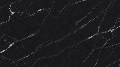 The primary subject of the image is a black marble countertop. The setting is a kitchen, with the countertop being the main focus of the scene. The visual style is a close-up of the marble countertop, showcasing its texture and pattern. The colors and mood of the image are predominantly dark, with the black marble countertop being the main source of contrast.
