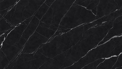 The primary subject of the image is a black marble countertop. The setting is a kitchen, with the countertop being the main focus of the scene. The visual style is a close-up of the marble countertop, showcasing its texture and pattern. The colors and mood of the image are predominantly dark, with the black marble countertop being the main source of contrast.
