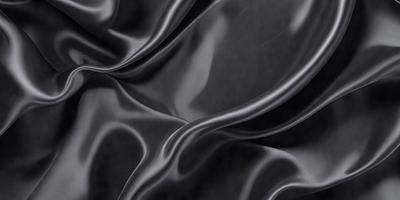 The primary subject of the image is a close-up of a black fabric, possibly a piece of silk or velvet. The setting is a dark background, which emphasizes the fabric's texture and color. The visual style appears to be a photo, as it captures the fabric's details and texture. The colors and mood of the image are predominantly dark, with the black fabric being the main focus.