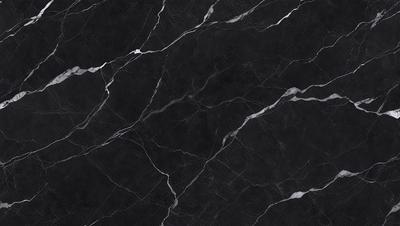 The primary subject of the image is a black marble countertop. The setting is a kitchen, with the countertop being the main focus of the scene. The visual style is a close-up of the marble countertop, showcasing its texture and pattern. The colors and mood of the image are predominantly dark, with the black marble countertop being the main source of contrast.