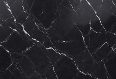 The primary subject of the image is a close-up of a marble surface, showcasing its intricate patterns and textures. The setting is a dark room, which contrasts with the light reflecting off the marble surface. The visual style is a black and white photo, emphasizing the contrast between the marble and the background. The colors and mood of the image are predominantly dark, with the marble surface acting as a focal point and source of interest.