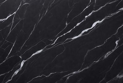 The primary subject of the image is a black marble countertop with a pattern of white veins. The setting is a kitchen, and the visual style is a close-up of the marble countertop. The colors and mood of the image are predominantly black and white, giving it a classic and elegant appearance.