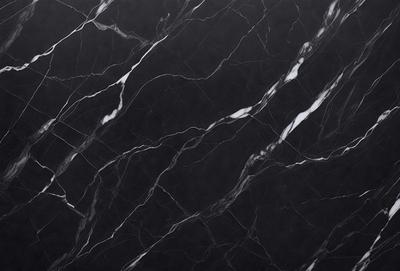 The primary subject of the image is a black marble countertop with white veins. The setting is a kitchen, and the visual style is a close-up of the marble countertop. The colors and mood of the image are predominantly black and white, giving it a sleek and modern appearance.