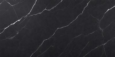 The primary subject of the image is a black marble countertop. The setting is a kitchen, with the countertop being the main focus of the scene. The visual style is a close-up of the marble countertop, showcasing its texture and pattern. The colors and mood of the image are predominantly dark, with the black marble countertop being the main source of contrast.