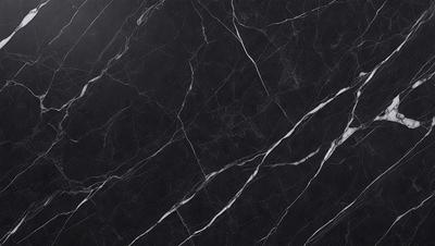 The primary subject of the image is a black marble countertop. The setting is a kitchen, with the countertop being the main focus of the scene. The visual style is a close-up of the marble countertop, showcasing its texture and pattern. The colors and mood of the image are predominantly dark, with the black marble countertop being the main source of contrast.