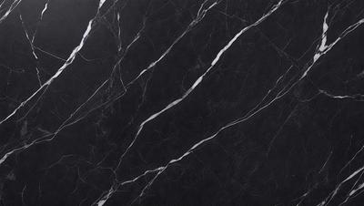 The primary subject of the image is a black marble countertop. The setting is a kitchen, with the countertop being the main focus of the scene. The visual style is a close-up of the marble countertop, showcasing its texture and pattern. The colors and mood of the image are predominantly dark, with the black marble countertop being the main source of contrast.