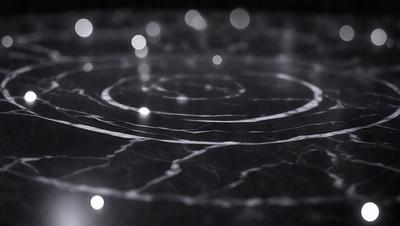 The primary subject of the image is a marble table with a patterned surface. The table is set against a black background, which adds a dramatic effect to the scene. The visual style of the image is a close-up of the marble table, showcasing its intricate pattern. The colors and mood of the image are predominantly dark, with the marble table and black background creating a moody and sophisticated atmosphere.
