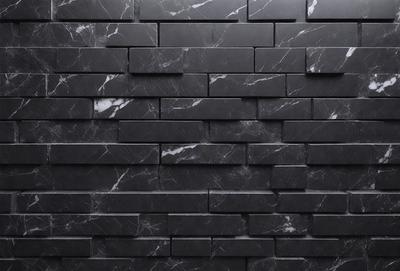 The primary subject of the image is a black marble wall with a brick pattern. The setting is a black and white photo, which gives the image a classic and timeless appearance. The visual style is a close-up of the marble wall, showcasing the intricate brick pattern. The colors and mood of the image are predominantly black and white, creating a sense of elegance and sophistication.