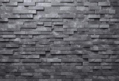 The primary subject of the image is a large, gray brick wall. The setting is a room with a brick wall, and the visual style is a photo. The dominant colors are gray and black, creating a moody atmosphere.