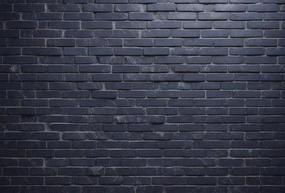 The primary subject of the image is a brick wall. The setting is a dark room, and the visual style is a photo. The dominant colors are black and grey, creating a moody atmosphere.