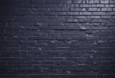 The primary subject of the image is a blue brick wall. The setting is a dark room, and the visual style is a close-up of the brick wall. The dominant colors are blue and black, creating a moody atmosphere.