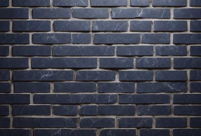 The primary subject of the image is a blue brick wall. The setting is a brick wall, and the visual style is a photo. The dominant colors are blue and gray, creating a calm and soothing atmosphere.