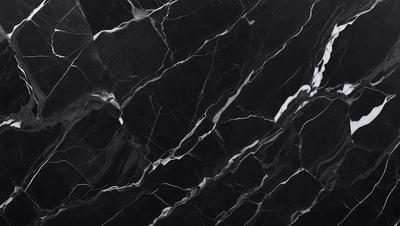 The primary subject of the image is a black marble countertop. The setting is a kitchen, with the countertop being the main focus of the scene. The visual style is a close-up of the marble countertop, showcasing its texture and pattern. The colors and mood of the image are predominantly dark, with the black marble countertop being the main source of contrast.