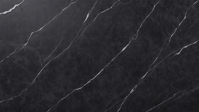 The primary subject of the image is a black marble countertop. The setting is a kitchen, with the countertop being the main focus of the scene. The visual style is a close-up of the marble countertop, showcasing its texture and pattern. The colors and mood of the image are predominantly dark, with the black marble countertop being the main source of contrast.