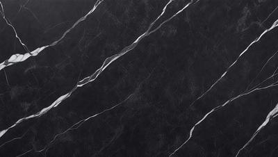 The primary subject of the image is a black marble countertop. The setting is a kitchen, with the countertop being the main focus of the scene. The visual style is a close-up of the marble countertop, showcasing its texture and pattern. The colors and mood of the image are predominantly dark, with the black marble countertop being the main source of contrast.