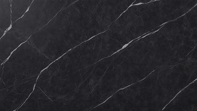 The primary subject of the image is a black marble countertop. The setting is a kitchen, with the countertop being the main focus of the scene. The visual style is a close-up of the marble countertop, showcasing its texture and pattern. The colors and mood of the image are predominantly dark, with the black marble providing a sleek and sophisticated appearance.