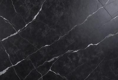 The primary subject of the image is a black marble countertop. The setting is a kitchen, with the countertop being the main focus of the scene. The visual style is a close-up of the marble countertop, showcasing its texture and pattern. The colors and mood of the image are predominantly dark, with the black marble countertop being the main source of contrast.