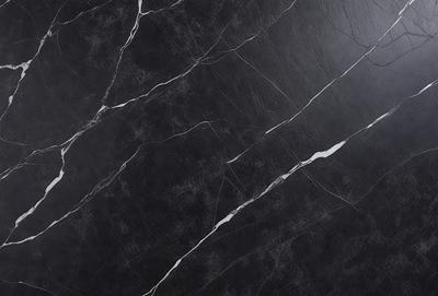 The primary subject of the image is a black marble countertop. The setting is a kitchen, with the countertop being the main focus of the scene. The visual style is a close-up of the marble countertop, showcasing its texture and pattern. The colors and mood of the image are predominantly dark, with the black marble countertop being the main source of contrast.