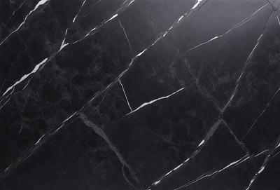 The primary subject of the image is a black marble countertop. The setting is a kitchen, with the countertop being the main focus of the scene. The visual style is a close-up of the marble countertop, showcasing its texture and pattern. The colors and mood of the image are predominantly dark, with the black marble countertop being the main source of contrast.