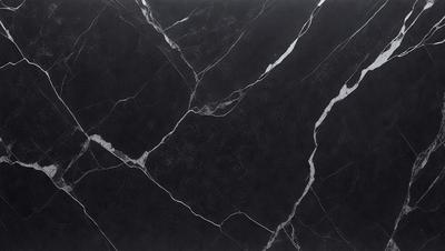 The primary subject of the image is a black marble countertop. The setting is a kitchen, with the countertop being the main focus of the scene. The visual style is a close-up of the marble countertop, showcasing its texture and pattern. The colors and mood of the image are predominantly dark, with the black marble countertop being the main source of contrast.