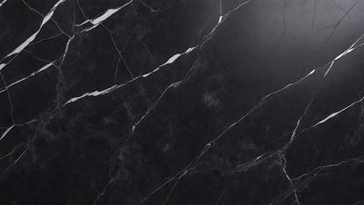The primary subject of the image is a black marble countertop. The setting is a kitchen, with the countertop being the main focus of the scene. The visual style is a close-up of the marble countertop, showcasing its texture and pattern. The colors and mood of the image are predominantly dark, with the black marble countertop being the main source of contrast.
