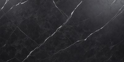 The primary subject of the image is a black marble countertop. The setting is a kitchen, with the countertop being the main focus of the scene. The visual style is a close-up of the marble countertop, showcasing its texture and details. The colors and mood of the image are predominantly dark, with the black marble countertop being the main source of contrast and visual interest.