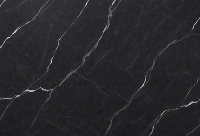 The primary subject of the image is a black marble countertop. The setting is a kitchen, with the countertop being the main focus of the scene. The visual style is a close-up of the marble countertop, showcasing its texture and pattern. The colors and mood of the image are predominantly dark, with the black marble countertop being the main source of contrast.