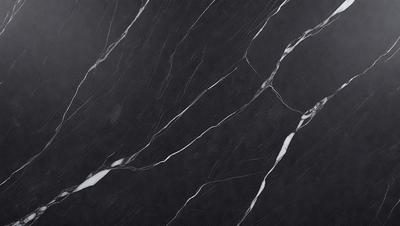 The primary subject of the image is a black marble countertop. The setting is a kitchen, with the countertop being the main focus of the scene. The visual style is a close-up of the marble countertop, showcasing its texture and details. The colors and mood of the image are predominantly dark, with the black marble countertop being the main source of contrast and visual interest.