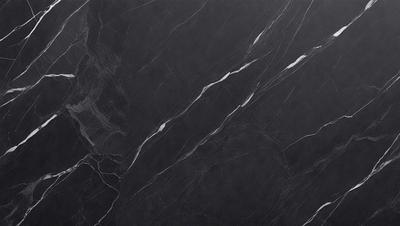 The primary subject of the image is a black marble countertop. The setting is a kitchen, with the countertop being the main focus of the scene. The visual style is a close-up of the marble countertop, showcasing its texture and details. The colors and mood of the image are predominantly dark, with the black marble countertop being the main source of contrast and visual interest.