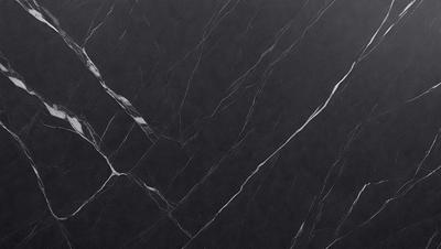 The primary subject of the image is a black marble countertop. The setting is a kitchen, with the countertop being the main focus of the scene. The visual style is a close-up of the marble countertop, showcasing its texture and pattern. The colors and mood of the image are predominantly dark, with the black marble providing a sleek and sophisticated appearance.