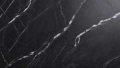 The primary subject of the image is a black marble countertop. The setting is a kitchen, with the countertop being the main focus of the scene. The visual style is a close-up of the marble countertop, showcasing its texture and pattern. The colors and mood of the image are predominantly dark, with the black marble countertop being the main source of contrast.