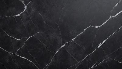 The primary subject of the image is a close-up of a marble countertop. The setting is a kitchen, with the countertop being the main focus of the scene. The visual style is a photo, capturing the intricate details of the marble surface. The colors and mood of the image are predominantly black and white, giving it a classic and elegant appearance.