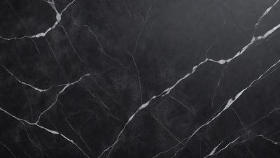 The primary subject of the image is a close-up of a black marble countertop. The setting is a kitchen, with the marble countertop being the main focus of the scene. The visual style is a photo, capturing the intricate details of the marble surface. The colors and mood of the image are predominantly dark, with the black marble providing a striking contrast against the lighter background.