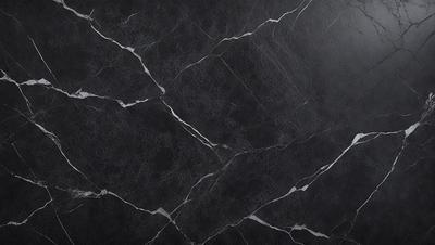 The primary subject of the image is a black marble countertop. The setting is a kitchen, with the countertop being the main focus of the scene. The visual style is a close-up of the marble countertop, showcasing its texture and pattern. The colors and mood of the image are predominantly dark, with the black marble countertop being the main source of contrast.