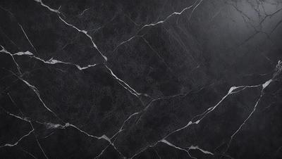 The primary subject of the image is a black marble countertop. The setting is a kitchen, with the countertop being the main focus of the scene. The visual style is a close-up of the marble countertop, showcasing its texture and details. The colors and mood of the image are predominantly dark, with the black marble countertop being the main source of contrast and visual interest.