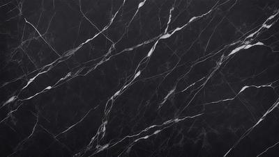 The primary subject of the image is a marble countertop with a black background. The countertop features a pattern of white and black veins, giving it a unique and elegant appearance. The visual style of the image is a close-up of the marble countertop, showcasing its intricate details. The colors and mood of the image are predominantly black and white, creating a sophisticated and timeless atmosphere.