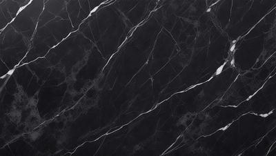 The primary subject of the image is a black marble countertop. The setting is a kitchen, with the countertop being the main focus of the scene. The visual style is a close-up of the marble countertop, showcasing its texture and pattern. The colors and mood of the image are predominantly dark, with the black marble countertop being the main source of contrast.