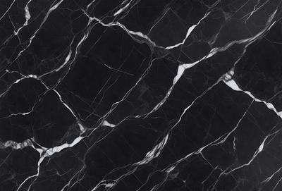 The primary subject of the image is a black and white marble pattern. The setting is a black background, which contrasts with the marble pattern. The visual style is a close-up of the marble pattern, showcasing its intricate details. The colors and mood of the image are predominantly black and white, giving it a classic and elegant appearance.
