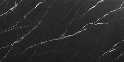 The primary subject of the image is a black marble countertop. The setting is a kitchen, with the countertop being the main focus of the scene. The visual style is a close-up of the marble countertop, showcasing its texture and details. The colors and mood of the image are predominantly dark, with the black marble countertop being the main source of contrast and visual interest.