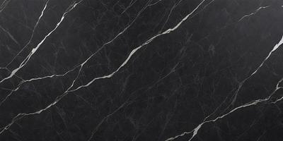 The primary subject of the image is a black marble countertop. The setting is a kitchen, with the countertop being the main focus of the scene. The visual style is a close-up of the marble countertop, showcasing its texture and pattern. The colors and mood of the image are predominantly dark, with the black marble providing a striking contrast against the surrounding environment.